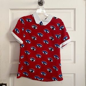 Short sleeved collared shirt with eye pattern